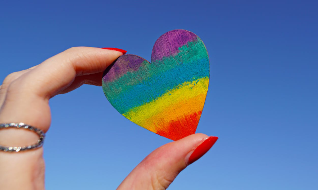 a person is holding a heart-shaped cutout