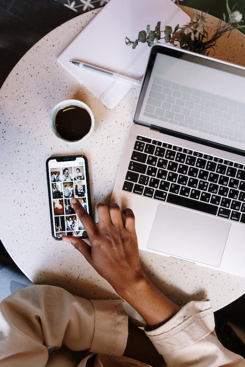 A person scrolling through social media looking at influencers, symbolizing the constant social comparison in the digital age.