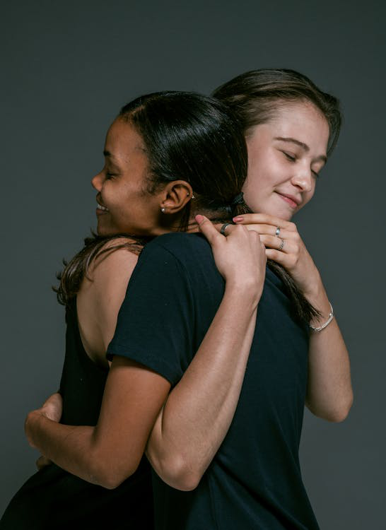 Two happy women embracing in a hug.